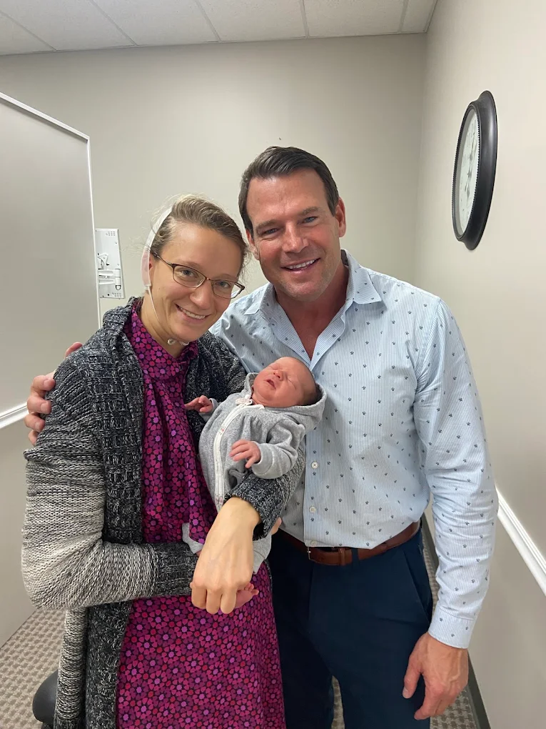 Pain Relief Evaluation - Cincinnati Ohio Chiropractor Dr. Baker with a mother and her newborn