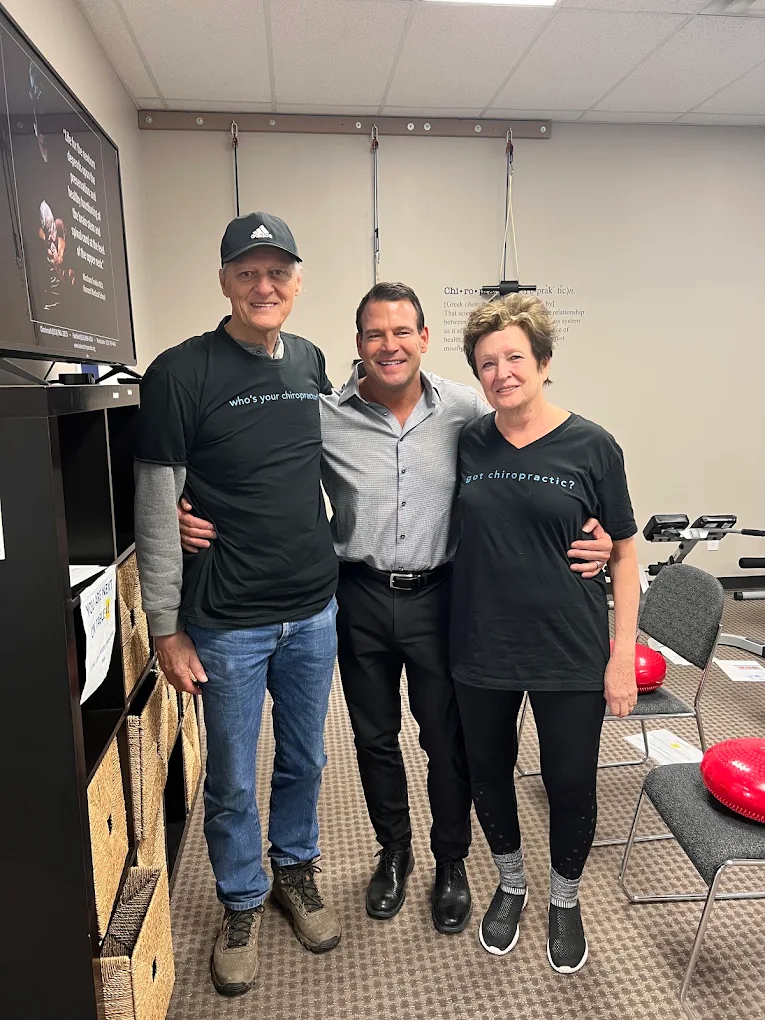 Pain Relief Evaluation - Cincinnati Ohio Chiropractor Dr. Baker with two happy patients in the Baker Chiropractic office